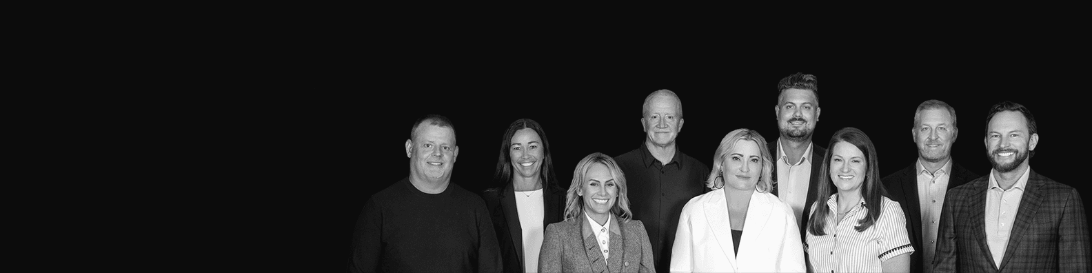 The Rule42 leadership team, photographed together against a black background.